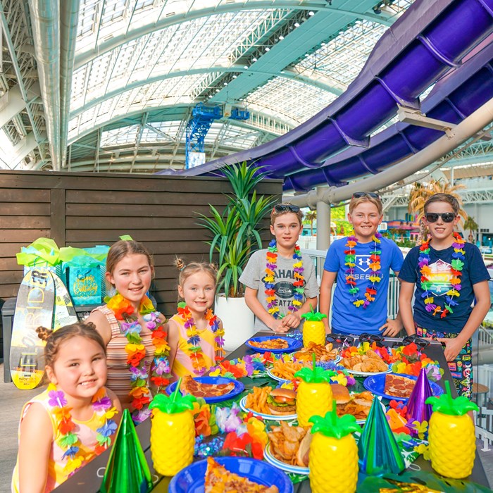 Guests enjoying exclusive birthday party packages at the World Waterpark with access to water slides, wave pools, and private spaces.